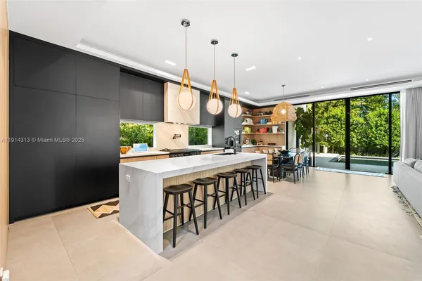 a kitchen with stainless steel appliances kitchen island a large island in the center