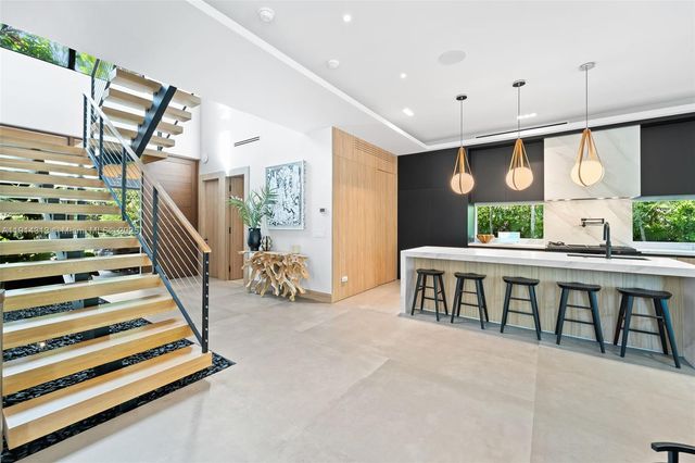 a view of entryway bedroom and hall with wooden floor