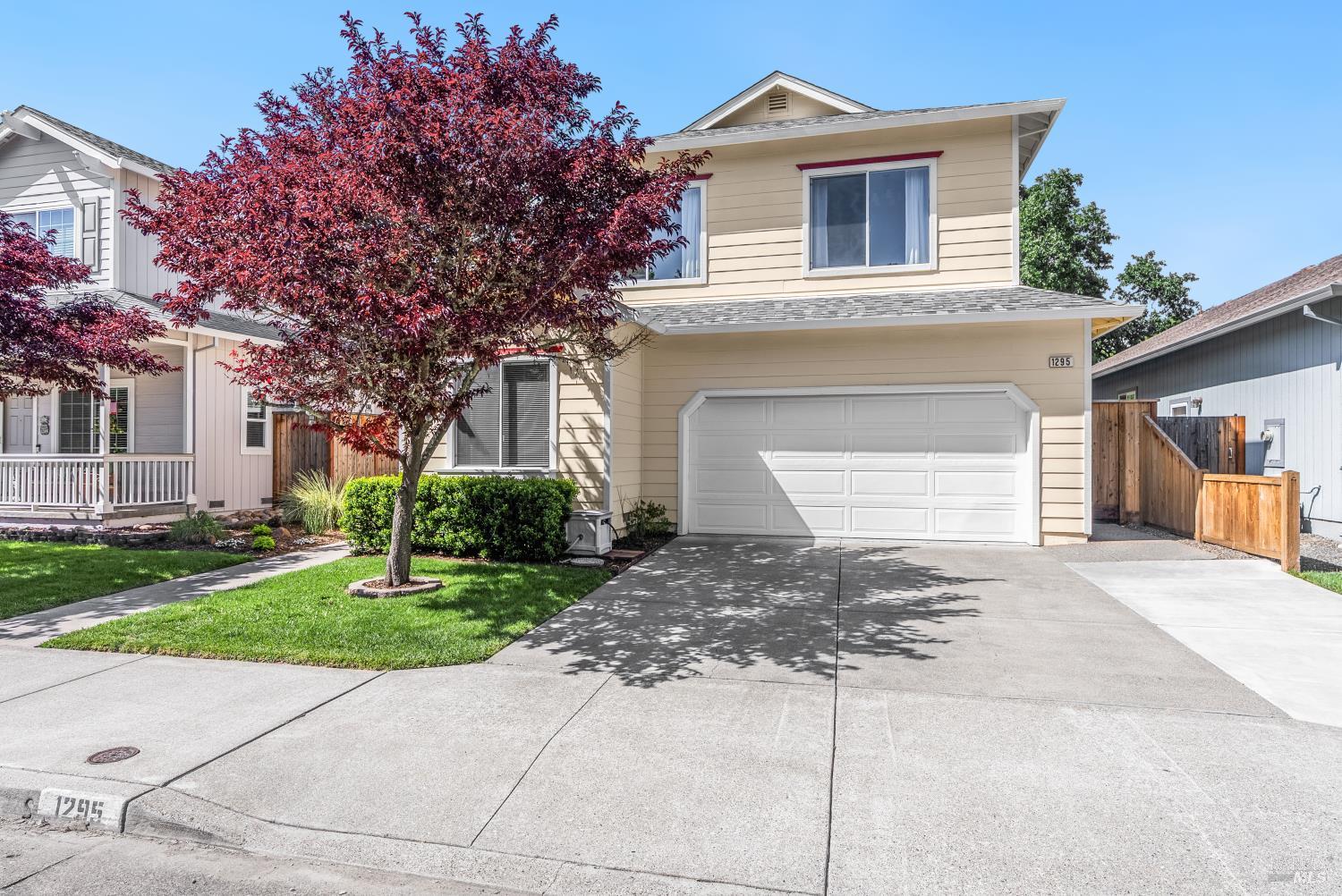 1295 Peterson Lane Santa Rosa, CA 95403 - Photo 1 of 1 a front view of a house with a yard and garage