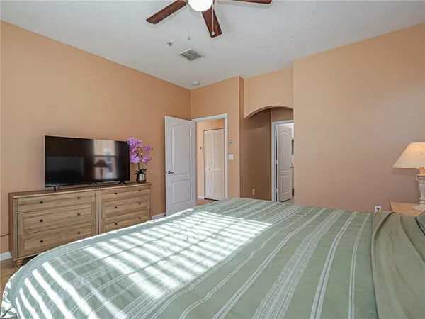 a bedroom with a bed and a flat screen tv