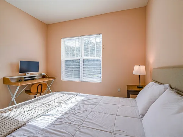 a bedroom with a bed and a tv