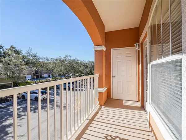 a view of a balcony with wooden floor and fence