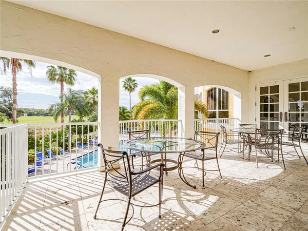 a view of a living room and balcony with furniture