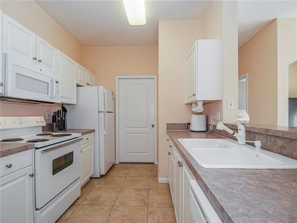 a kitchen with a sink stove and refrigerator