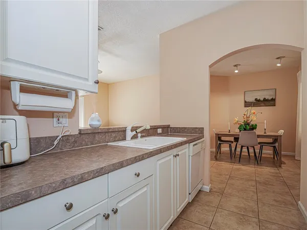 a spacious bathroom with a granite countertop sink and a mirror