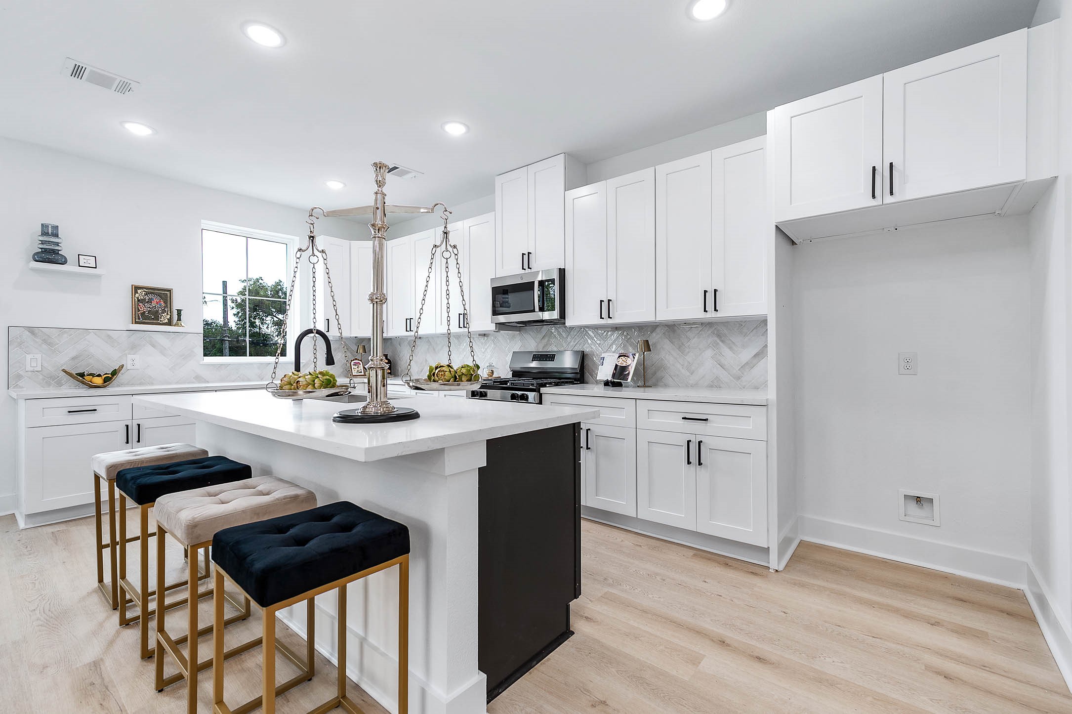 1515 Euel Street Houston, TX 77009 - Photo 12 of 34 Stunning modern kitchen with a large island, sleek cabinetry, and stylish pendant lighting—ideal for cooking, gathering, and entertaining.