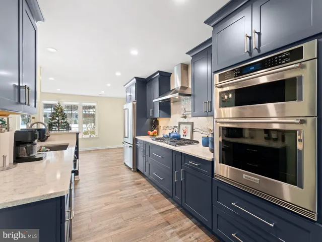 a kitchen with stainless steel appliances kitchen island granite countertop a stove and cabinets