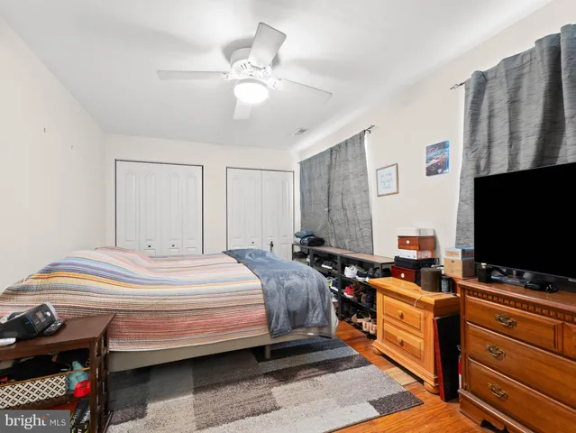 a bedroom with bed and flat screen tv