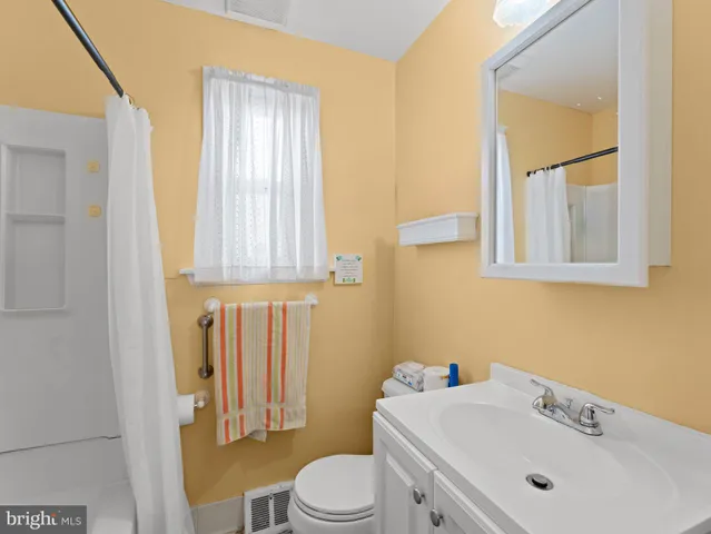 a bathroom with a sink a toilet and tub