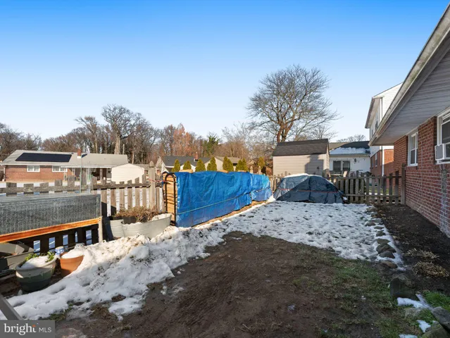 a view of roof deck with a barbeque and wooden fence