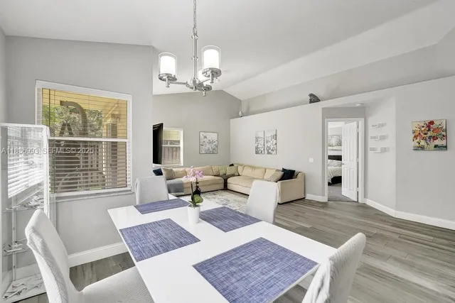 a living room with furniture a window and a table