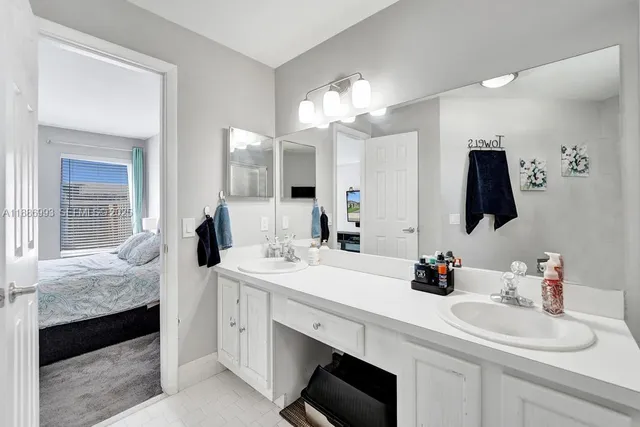 a bathroom with a sink double vanity and a mirror