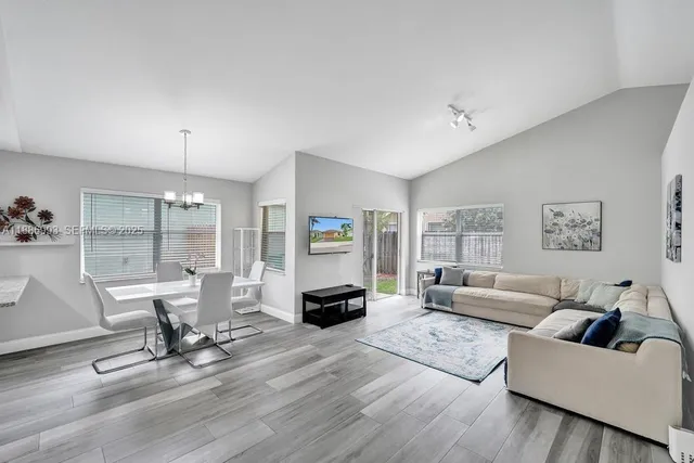 a living room with furniture and a chandelier