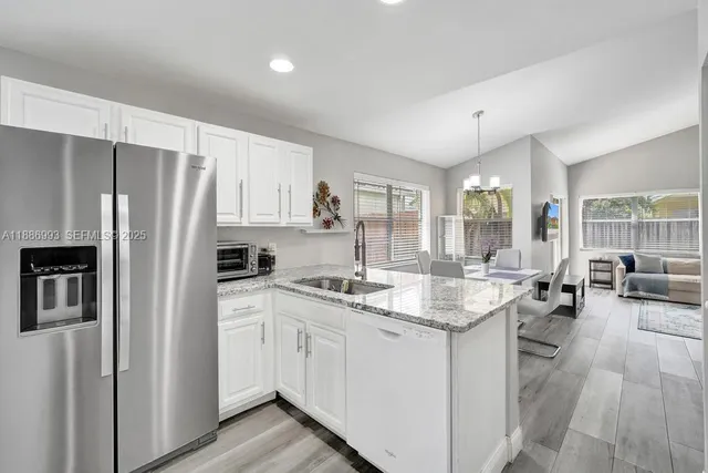 a kitchen with a sink stove and refrigerator