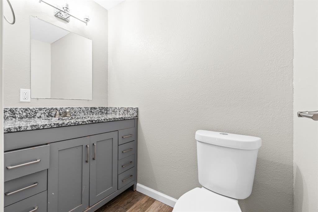 1210 Southey Street Waco, TX 76704 - Photo 12 of 29 a bathroom with a toilet sink and mirror