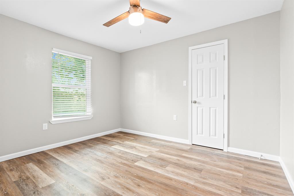 1210 Southey Street Waco, TX 76704 - Photo 13 of 29 a view of empty room with wooden floor and fan