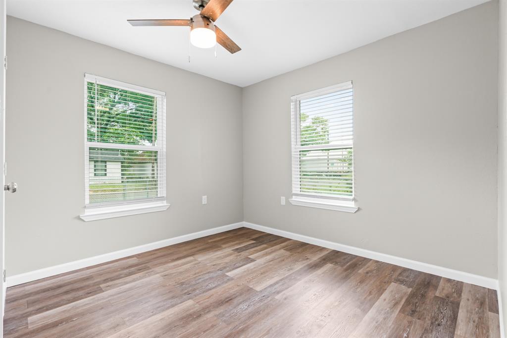 1210 Southey Street Waco, TX 76704 - Photo 15 of 29 a view of an empty room with wooden floor and a window
