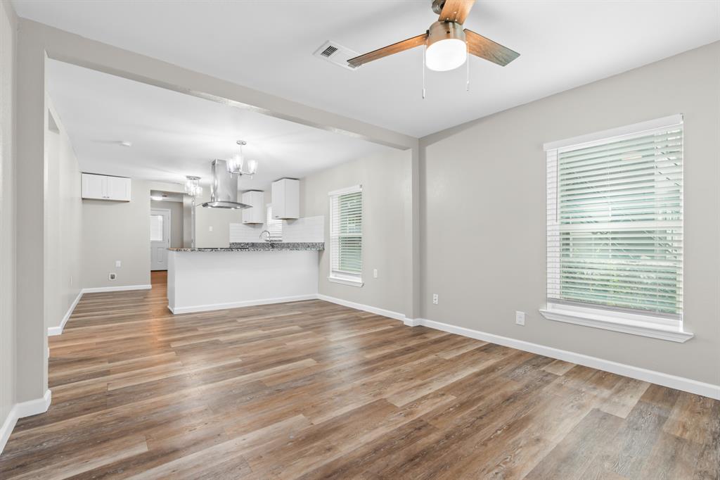 1210 Southey Street Waco, TX 76704 - Photo 5 of 29 a view of a kitchen with wooden floor a sink and windows
