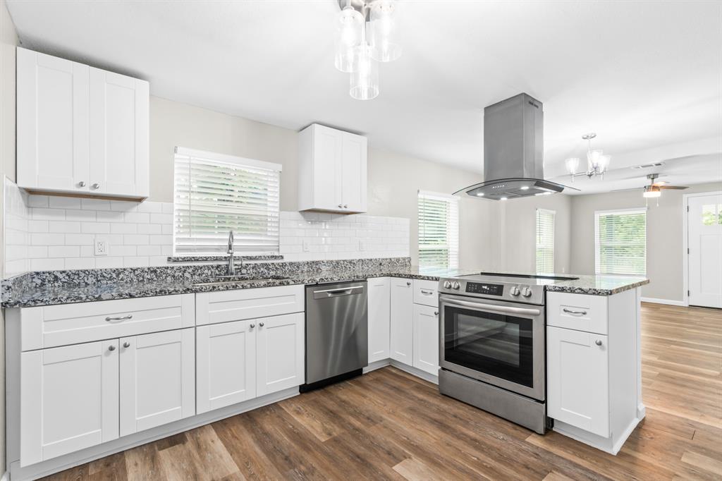 1210 Southey Street Waco, TX 76704 - Photo 8 of 29 a kitchen with granite countertop a sink cabinets stainless steel appliances and a window