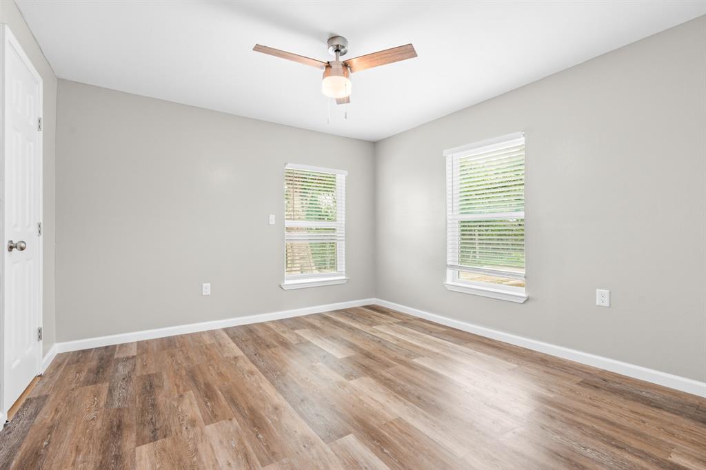 1210 Southey Street Waco, TX 76704 - Photo 9 of 29 wooden floor in an empty room with a window