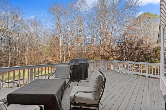 a kitchen with stainless steel appliances kitchen island granite countertop a sink a center island and a refrigerator