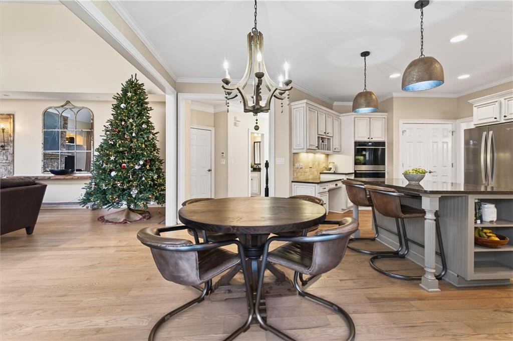 248 Cedarhurst Drive Canton, GA 30115 - Photo 18 of 76 a dining room with wooden floor a chandelier a wooden table and chairs