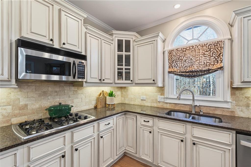 248 Cedarhurst Drive Canton, GA 30115 - Photo 21 of 76 a kitchen with stainless steel appliances granite countertop a sink a stove and cabinets