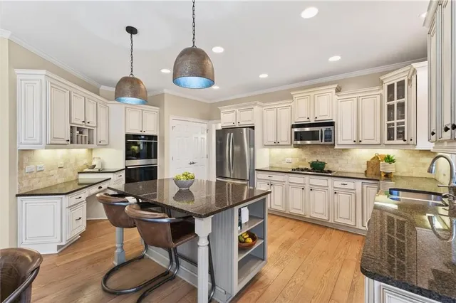 a bedroom with a large bed a flat screen tv and a window