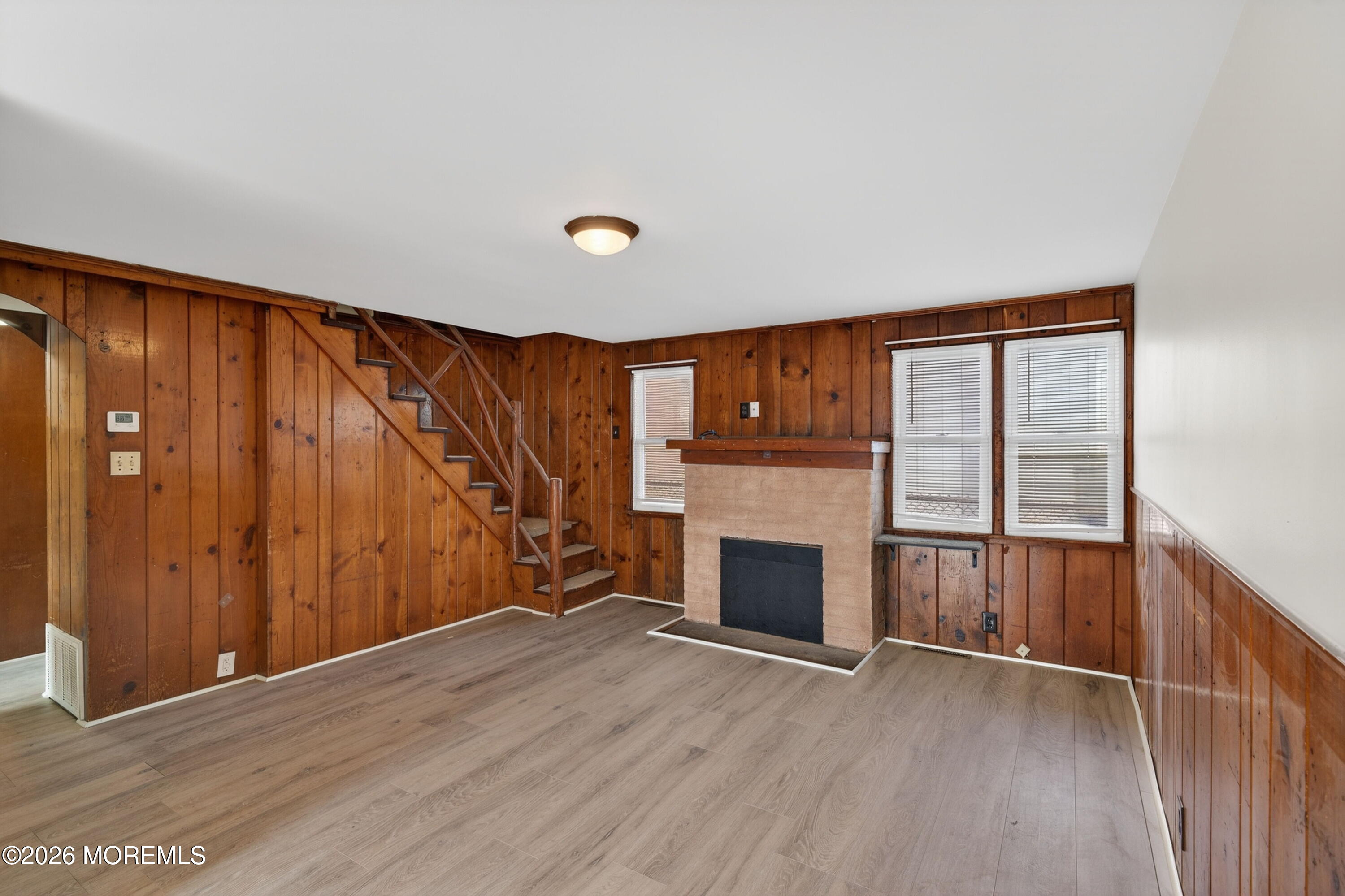 11 Cedar Road Brick, NJ 08723 - Photo 11 of 39 an empty room with wooden floor fireplace and windows