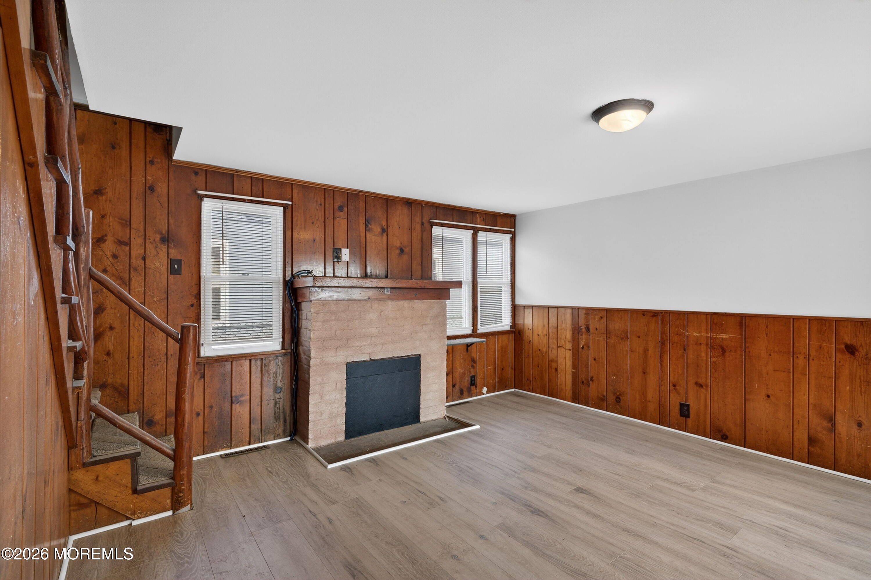 11 Cedar Road Brick, NJ 08723 - Photo 12 of 39 a view of an empty room with wooden floor and a fireplace