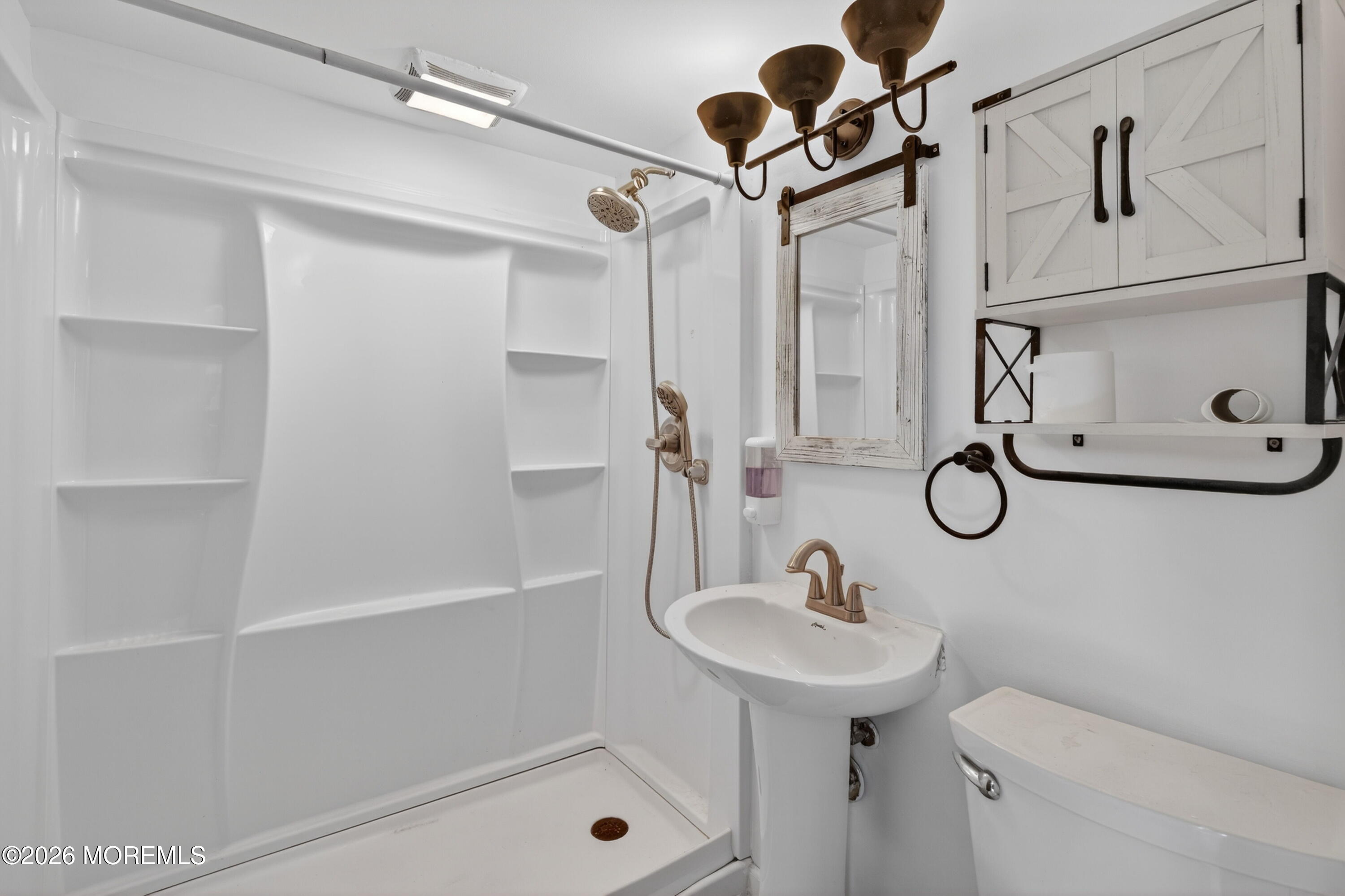 11 Cedar Road Brick, NJ 08723 - Photo 15 of 39 a bathroom with a sink a toilet and shower