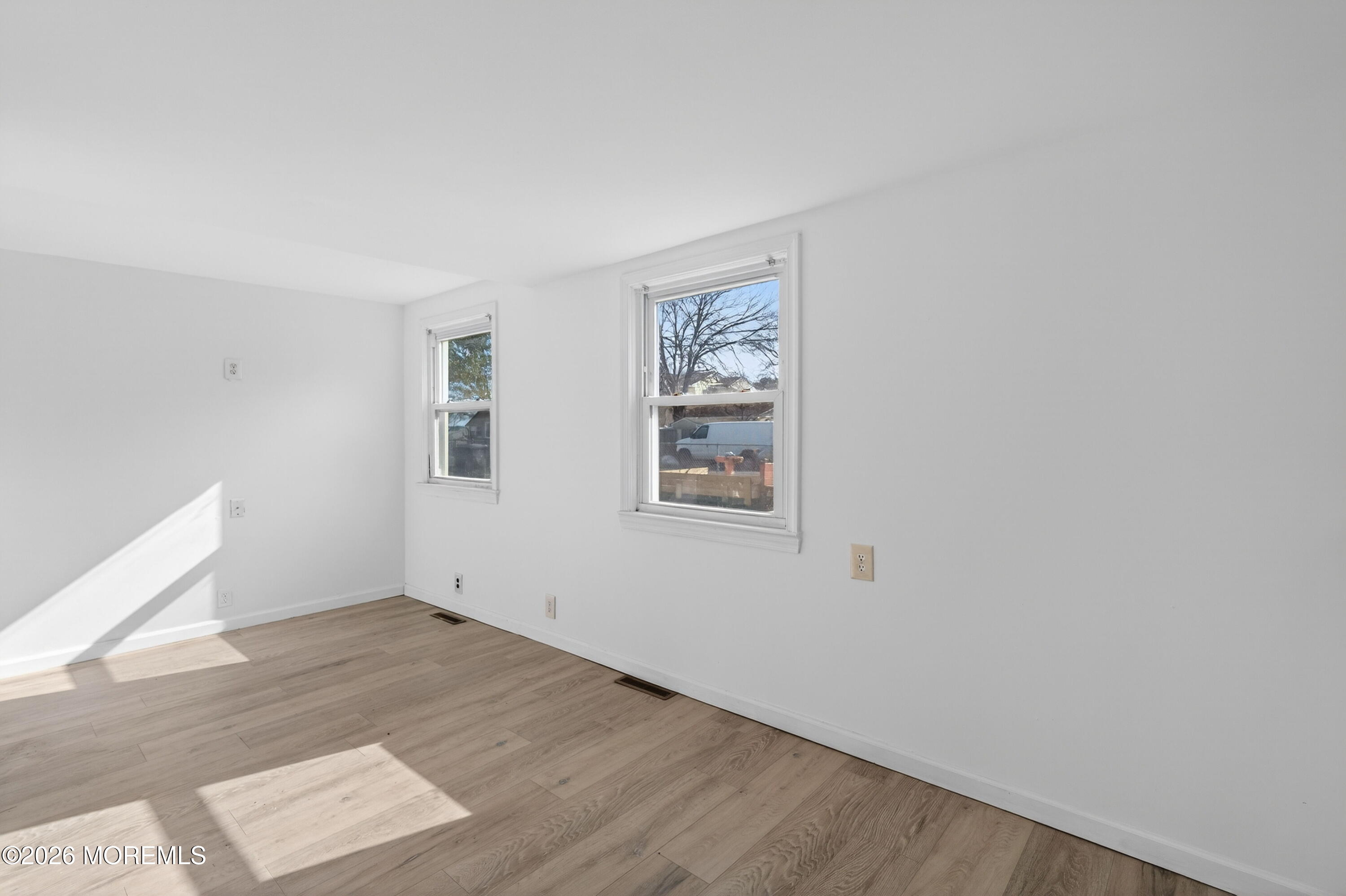 11 Cedar Road Brick, NJ 08723 - Photo 18 of 39 an empty room with wooden floor and windows