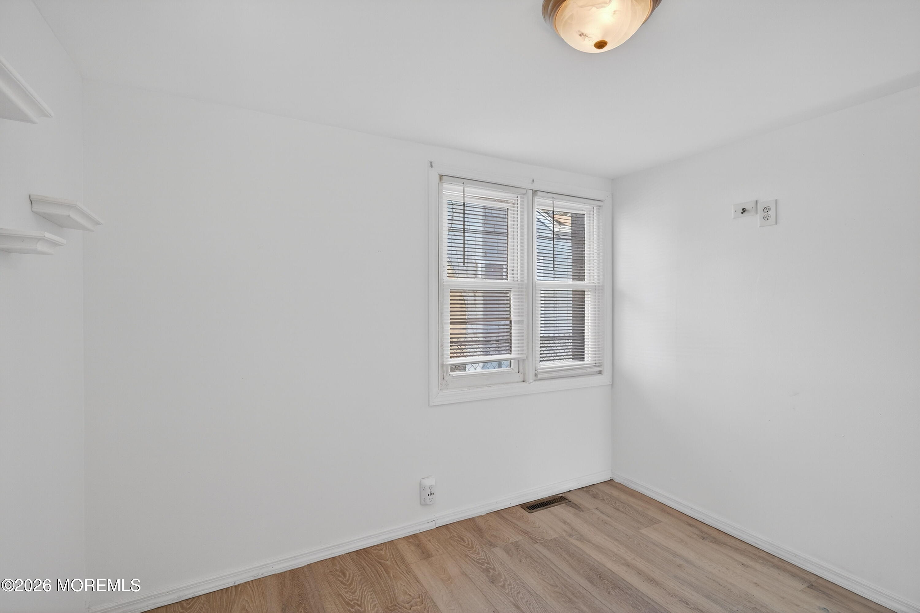 11 Cedar Road Brick, NJ 08723 - Photo 20 of 39 a view of an empty room with wooden floor and a window