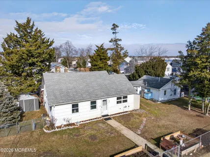 a aerial view of a house with a yard and sitting area