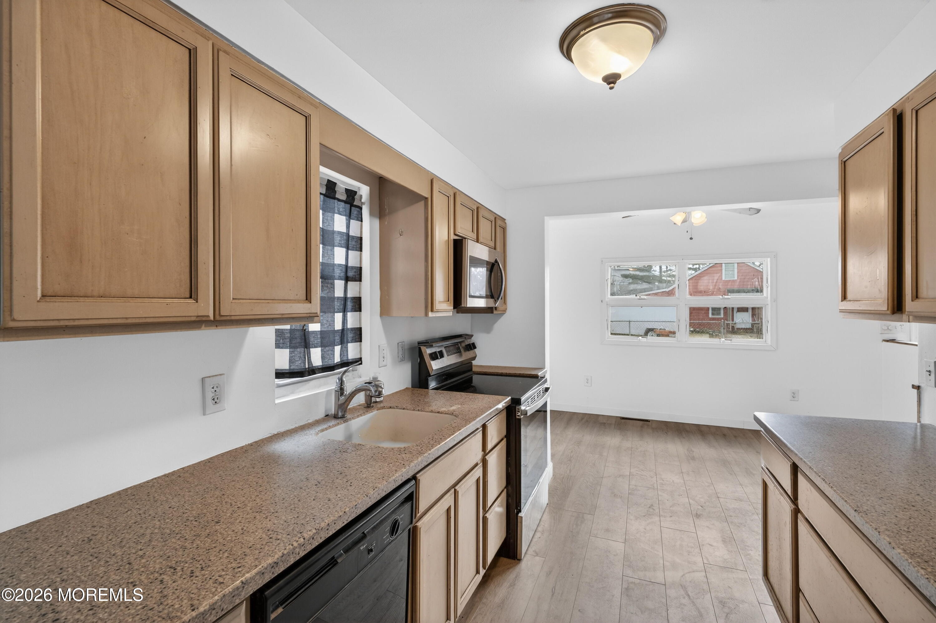 11 Cedar Road Brick, NJ 08723 - Photo 33 of 39 a kitchen with stainless steel appliances granite countertop a sink and a stove