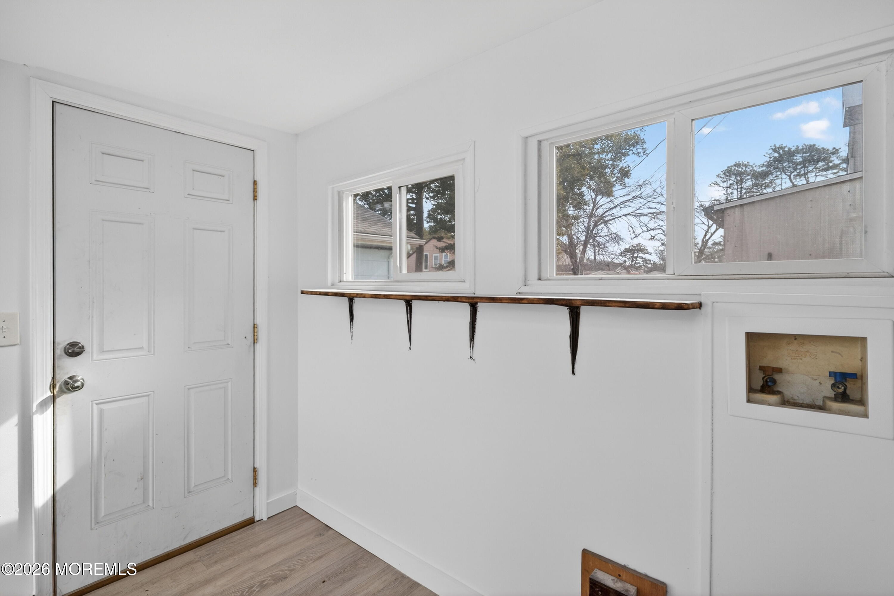 11 Cedar Road Brick, NJ 08723 - Photo 37 of 39 a view of a hallway with wooden floor and cabinet