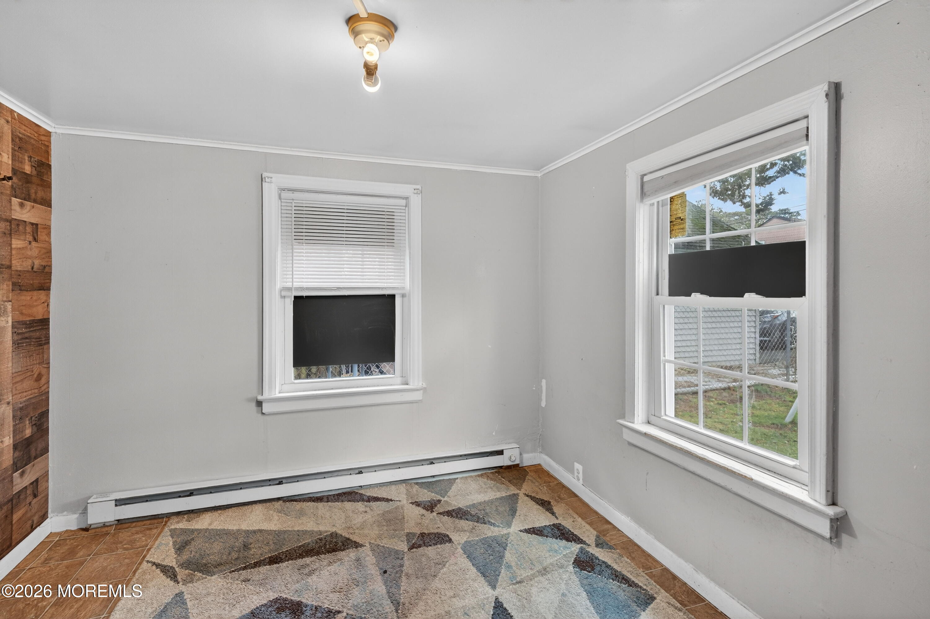 11 Cedar Road Brick, NJ 08723 - Photo 38 of 39 a view of an empty room with a window and wooden floor