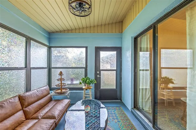 a bedroom with furniture and large windows
