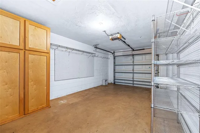 a view of a chair and table in backyard of the house