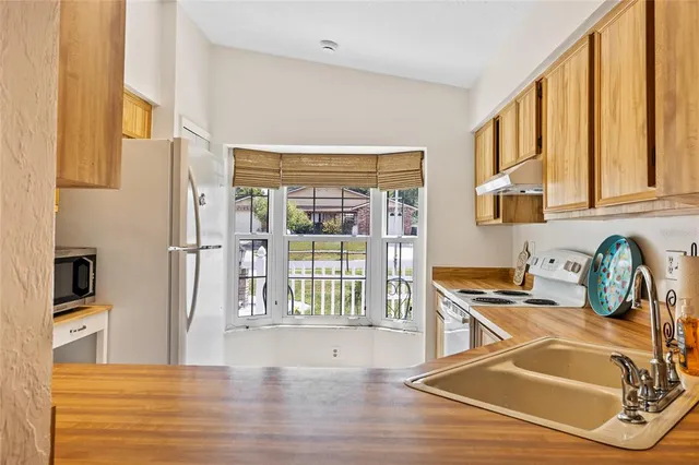a kitchen with granite countertop a stove and a refrigerator