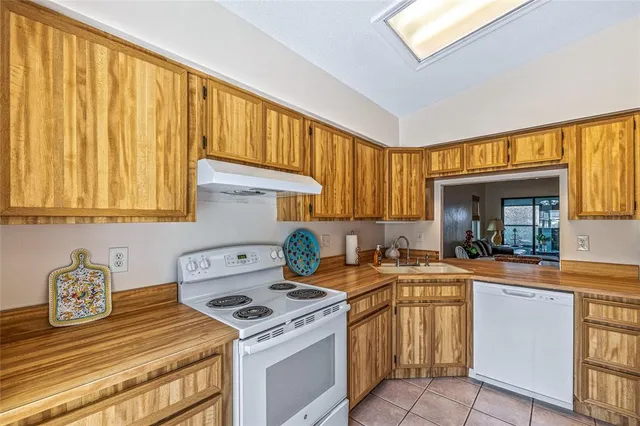 a kitchen with a stove a sink and a refrigerator