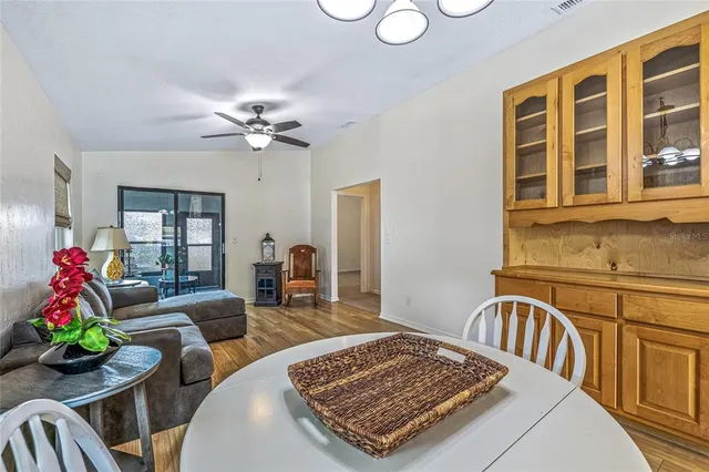 a living room with furniture a chandelier and a table