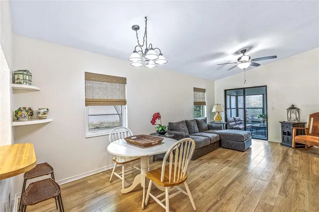 a view of a dining room with furniture window and wooden floor