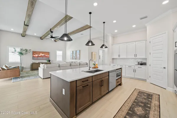 a view of a dining room with furniture wooden floor and chandelier