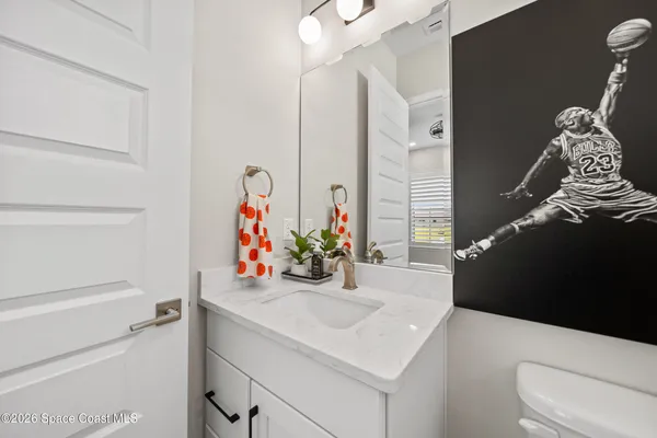 a bathroom with a sink vanity and a mirror