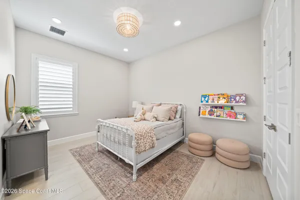 a living room with furniture and view of kitchen