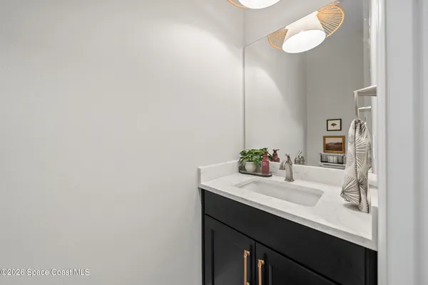 a sign of golf club on a wall under a tree