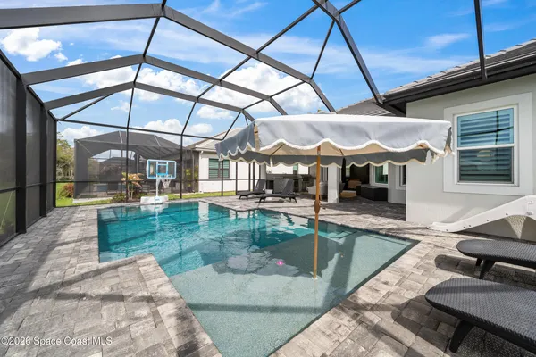 an aerial view of a house with a big yard and large trees