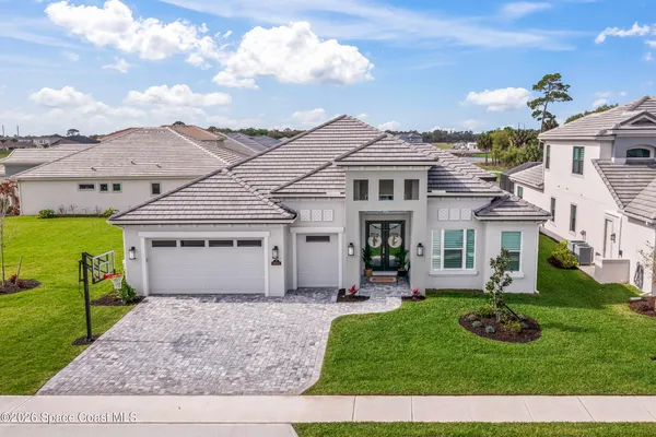 an aerial view of residential houses with outdoor space and ocean view