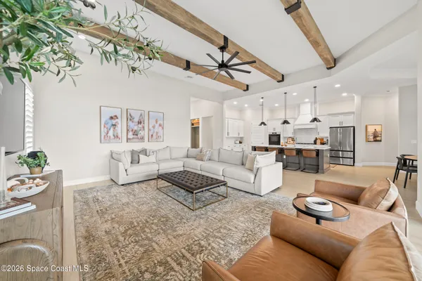 a kitchen with stainless steel appliances a sink a stove a refrigerator cabinets and wooden floor